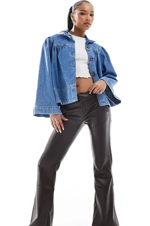 Bershka Petite faux leather flared trousers in
