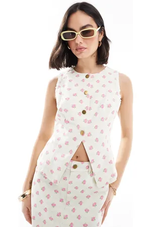 The Frolic Exclusive button through split front denim waistcoat co-ord in cream and pink floral