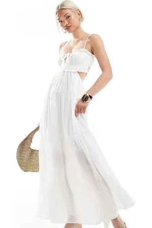 The Frolic Exclusive tie front ruffle trim open back tiered maxi dress in