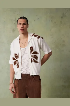 ASOS Relaxed boxy fit knitted button through polo with floral embroidery in ecru