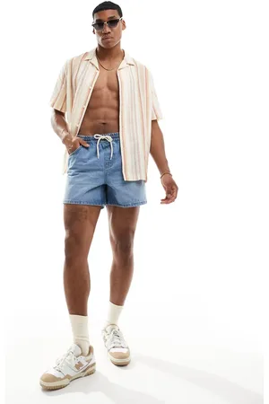 ASOS Wide shorter length denim shorts with elasticated waist in mid wash