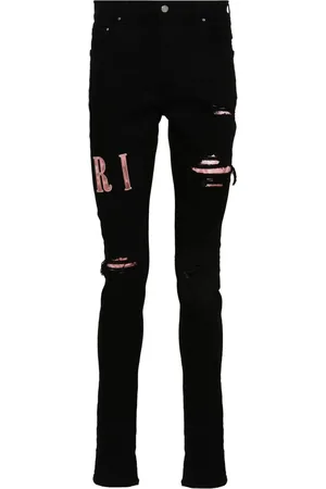 AMIRI Waxed logo-appliqué skinny jeans