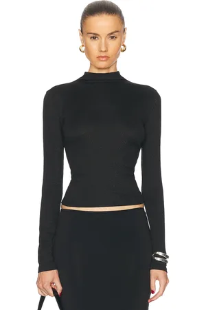 Frame Turtleneck Top in Black - Black. Size L (also in M, S, XS).
