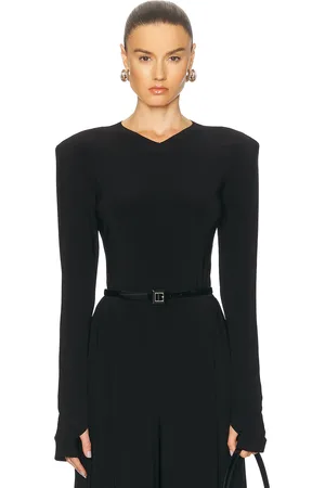 Norma Kamali Long Sleeve Shoulder Pad V Neck Top in Black - Black. Size L (also in ).