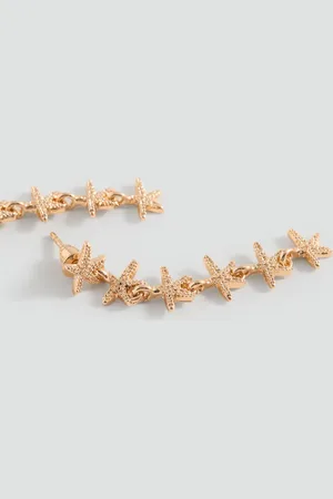 MANGO Long star earrings